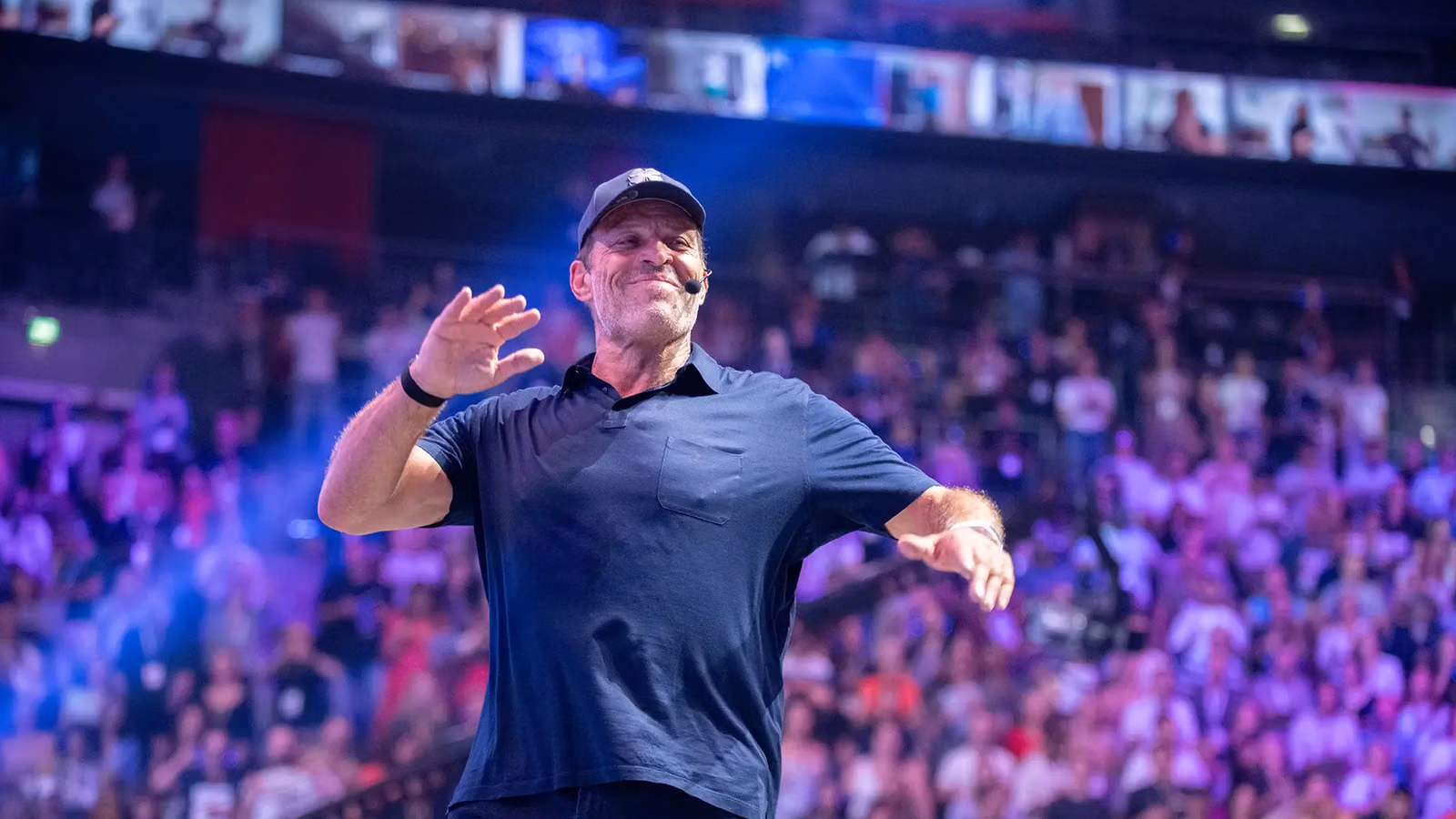 Tony Robbins speaking to an audience at an event